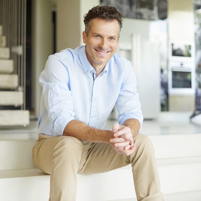 Enjoy my life. Shot of a handsome smiling man relaxing his moder